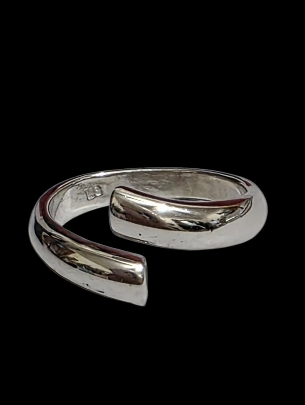 Sterling silver bypass ring  features a sleek, open-ended design